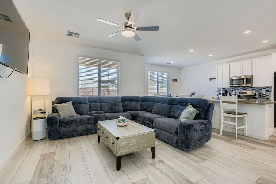 Living room with a sectional sofa, coffee table and kitchen